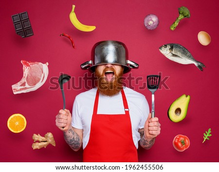 Man chef is ready to fight in the kitchen. burgundies background Imagine de stoc © 