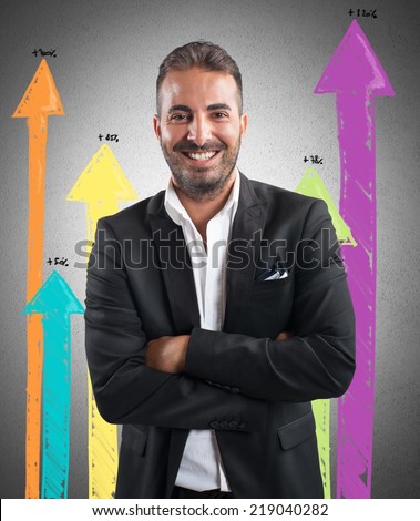 Happy successful businessman with positive statistics trend