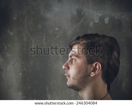 A man profile in a gray wall