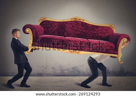 Men carrying a very heavy antique sofa