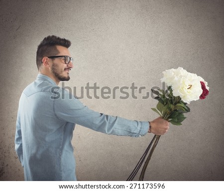 Nerd boy gives flowers to a girl