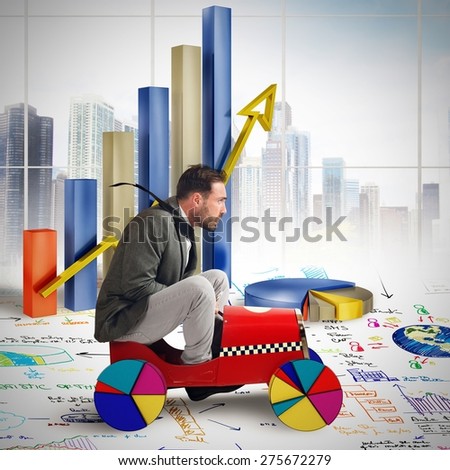 Businessman driving between growth diagrams and statistics