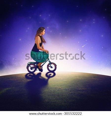 Girl with bike ride under the stars