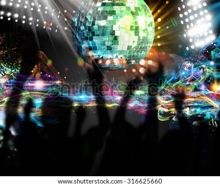 Silhouettes of many people dancing in nightclub