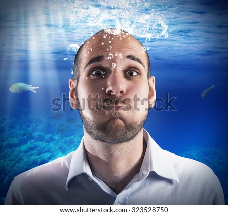 Helpless man holds his breath under water