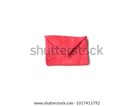 Red envelopes made from plasticine clay dough placed on white background