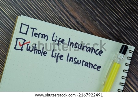 Concept of Whole Life Insurance write on a book isolated on Wooden Table. 商業照片 © 