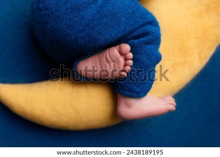 Similar – Image, Stock Photo Baby legs dangling from high chair; baby wearing turquoise outfit with bare feet against white wood background