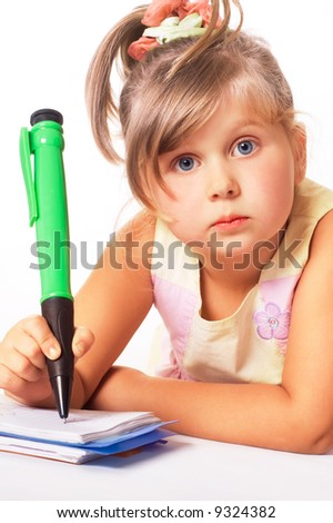 blue-eyed little girl with big green pen isolated on white