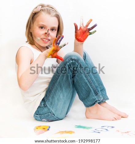 Happy child with colorful painted hands.