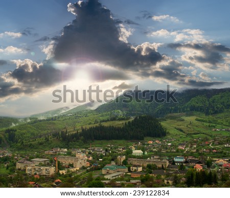 Landscape mountain town with a stormy,dramatic sky in the late spring.