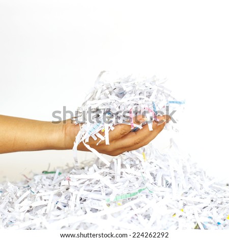 Hand holding Scrap Paper from paper cutter