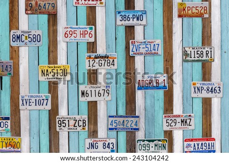 PHETCHABURI, THAILAND - January 8 : Old US car registration plate on wall at the shop in Phetchaburi on January 8, 2014, collection of old vintage style car registration.