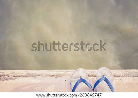White rubber shoe on Cement Edge near sea, Retro filter effect