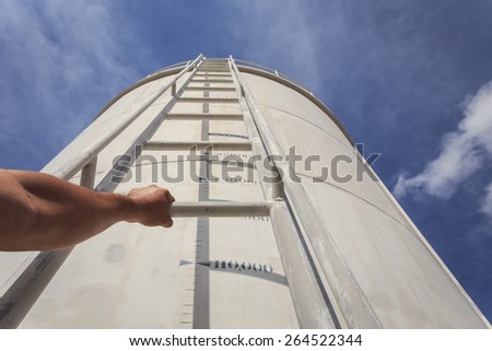 Close up Hand holding ladder on big water tank