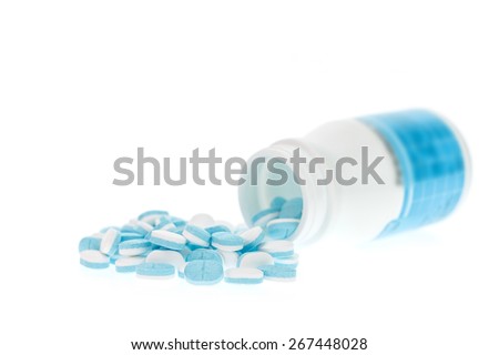 White plastic with pile of medicine isolated on white background
