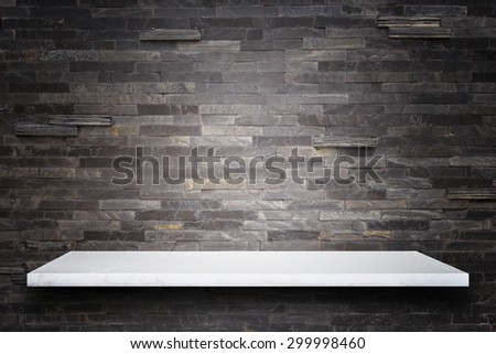 Empty top of natural stone shelves and stone wall background. For product display