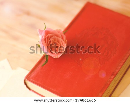 Book and rose on wood table