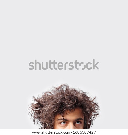 Similar – Image, Stock Photo Long haired young handsome man on a black background with a light illuminating his face, with a flirtatious expression for the camera showing a slight smile