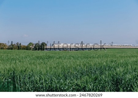 Similar – Image, Stock Photo Passenger train and rapeseed field. Spring landscape at sunrise