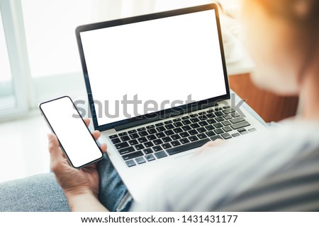 mockup image blank screen computer,cell phone with space for advertising text,hand using laptop texting mobile contact business searching information in workplace desk in office.design creative work 商業照片 © 