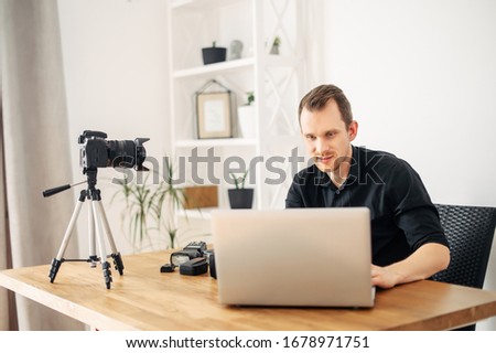 Similar – Image, Stock Photo Young man recording himself while playing guitar and singing to share the video in social media. Musician recording a music video at home.