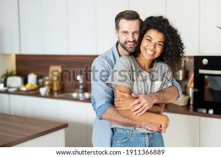 Similar – Image, Stock Photo Positive multiethnic couple embracing on street