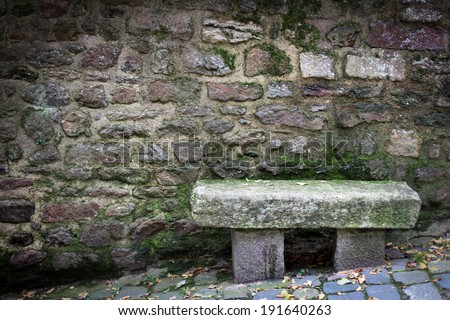 Bench in front of a stone wall, Dinan, Cotes-D\'Armor, Brittany, France