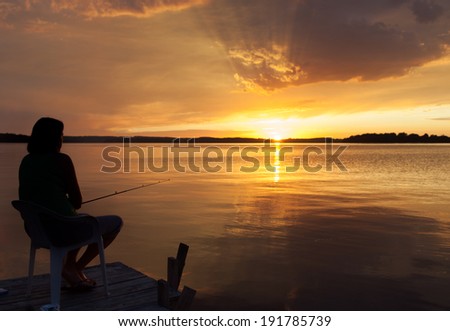 Silhouette of a woman fishing in a bay, Georgian Bay, Tobermory, Ontario, Canada