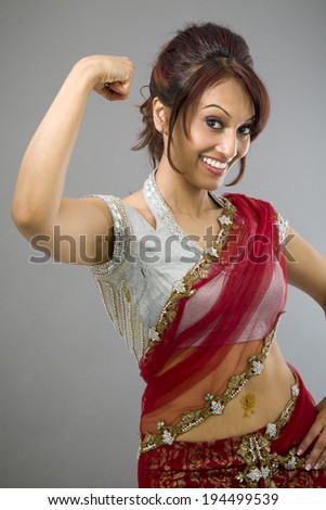 Young Indian woman showing off her muscle