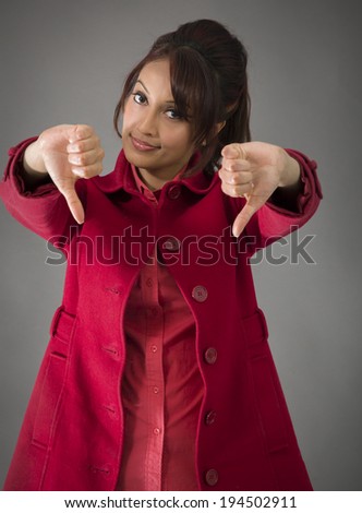 Indian young woman showing thumbs down sign from both hands