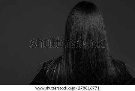 Model isolated on plain background in studio from behind