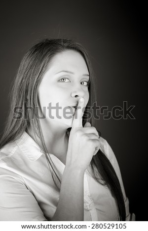 model isolated with finger on lips secret