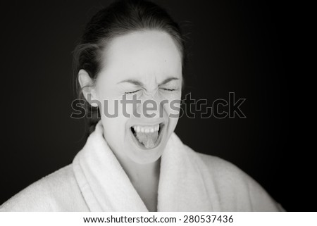 model isolated on plain background face sticking tongue out