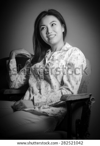Attractive Asian girl in her 20s at the theatre isolate on a white background, black and white image