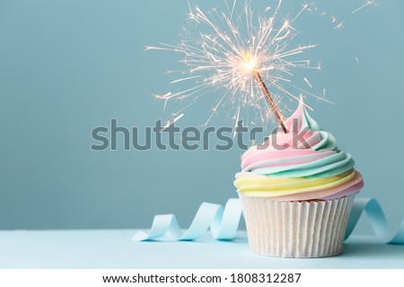 Pastel rainbow birthday cupcake with sparkler