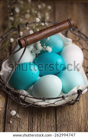 Dyed Easter eggs in a wire basket