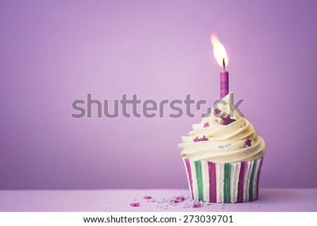 Purple birthday cupcake with copy space to side