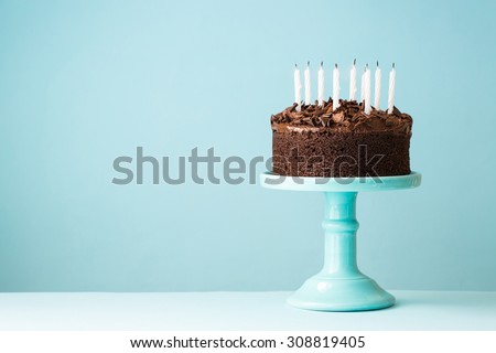 Chocolate birthday cake with blown out candles
