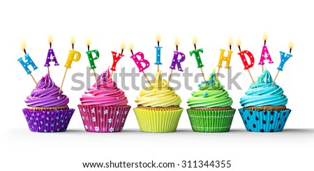 Row of colorful birthday cupcakes isolated on a white background