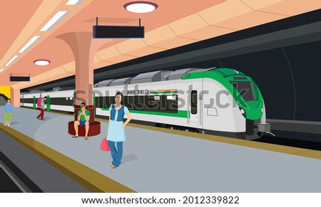 Subway train arriving at metro platform. Passengers standing and sitting in modern metro station