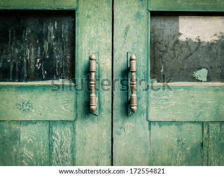 Old wooden doors painted in green