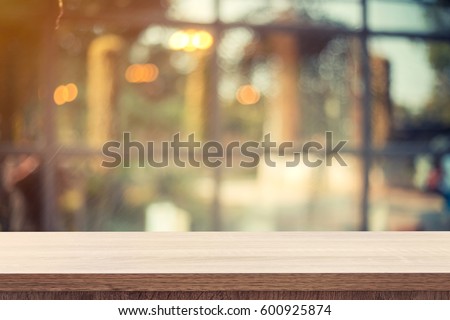 Empty wooden table for product or montage display and blurred coffee shop backdrop. Stockfoto © 