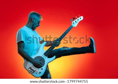 Image, Stock Photo Man with electric bass and bare feet on wooden bench on terrace in autumn