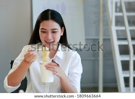 Similar – Image, Stock Photo Young female eating noodles and watching TV