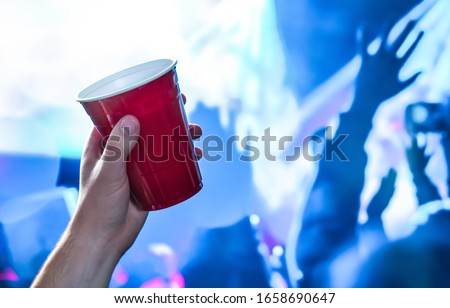 Similar – Image, Stock Photo Hand holding red cup with steaming drink against the light