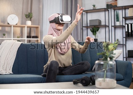 Similar – Image, Stock Photo Arab woman in VR headset on embankment