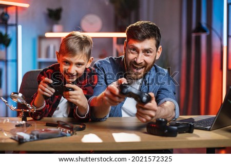 Similar – Image, Stock Photo Father and son using digital tablet together at night in bed