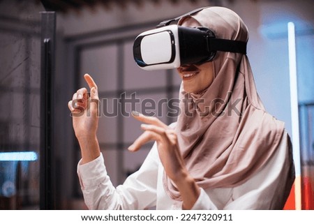 Similar – Image, Stock Photo Arab woman in VR headset on embankment