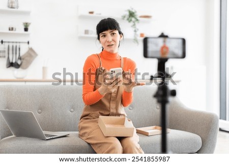 Similar – Image, Stock Photo Woman in her twenties with electric scooter recording voice note with a smartphone outdoors.